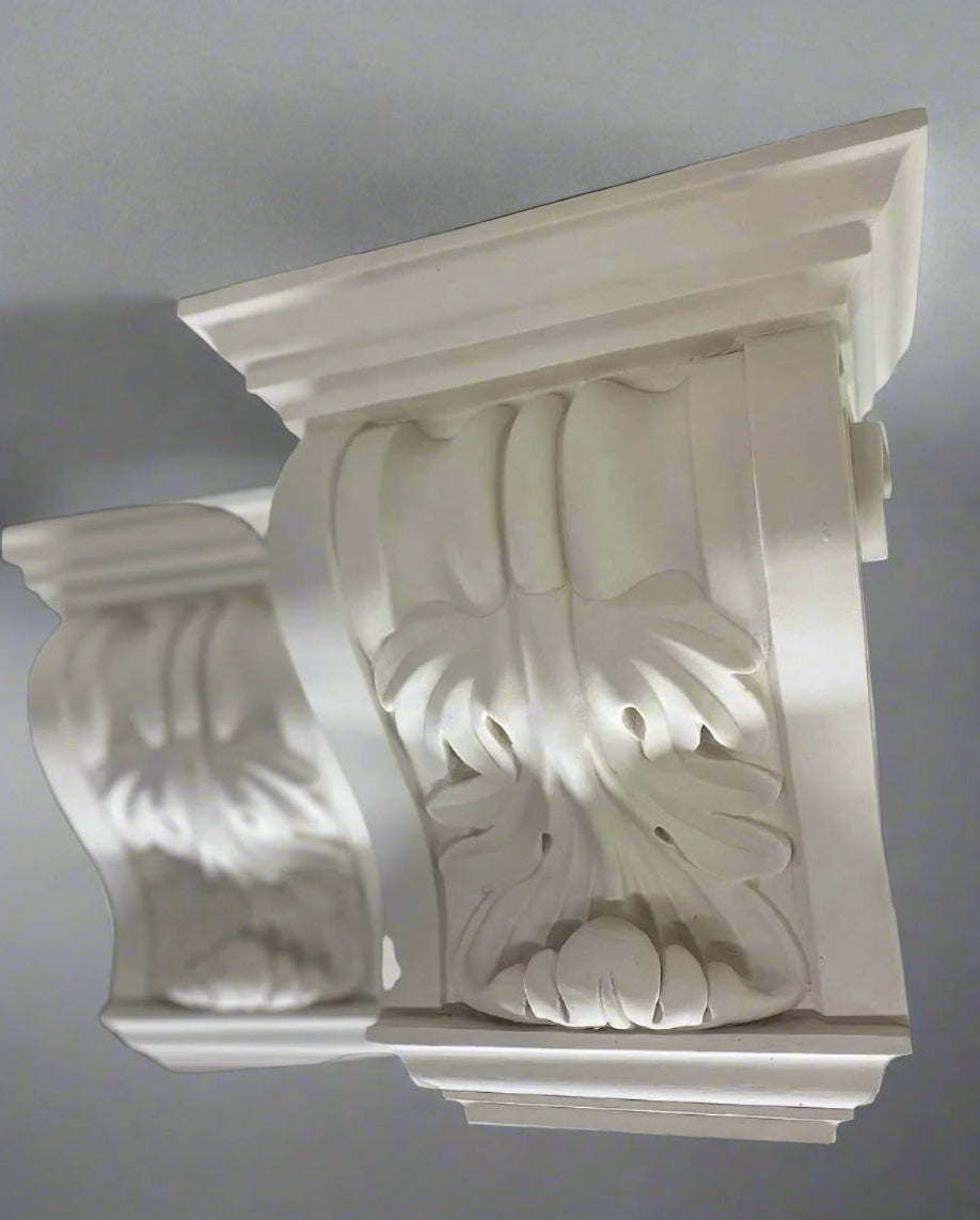 Decorative white corbel with intricate carvings on a black background