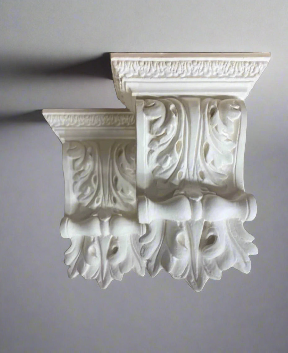 Decorative white bookends with intricate designs on a gray background