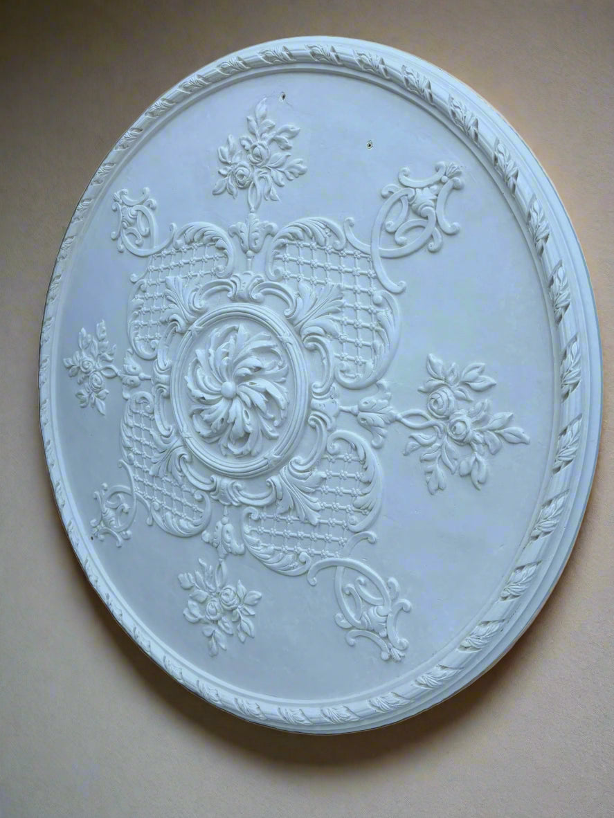 Decorative round ceiling medallion with intricate patterns on a rustic background